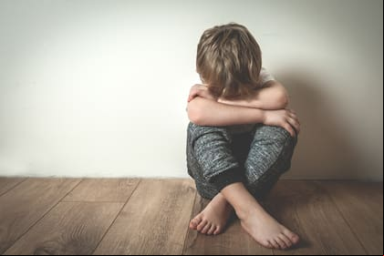 Boy crying covered his face with his hands. Stressed child. Domestic Family violence and aggression concept violence. concept for bullying, depression stress or frustration.