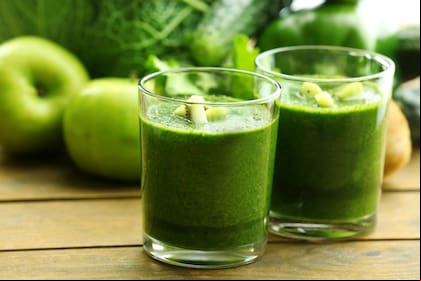 Green fresh healthy juice with fruits and vegetables on wooden table background