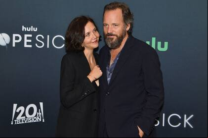 US actress Maggie Gyllenhaal (L) and husband US actor Peter Sarsgaard attend the Hulu premiere of "Dopesick" at the Museum of Modern Art (MoMA) on October 4, 2021 in New York City. (Photo by Angela Weiss / AFP)